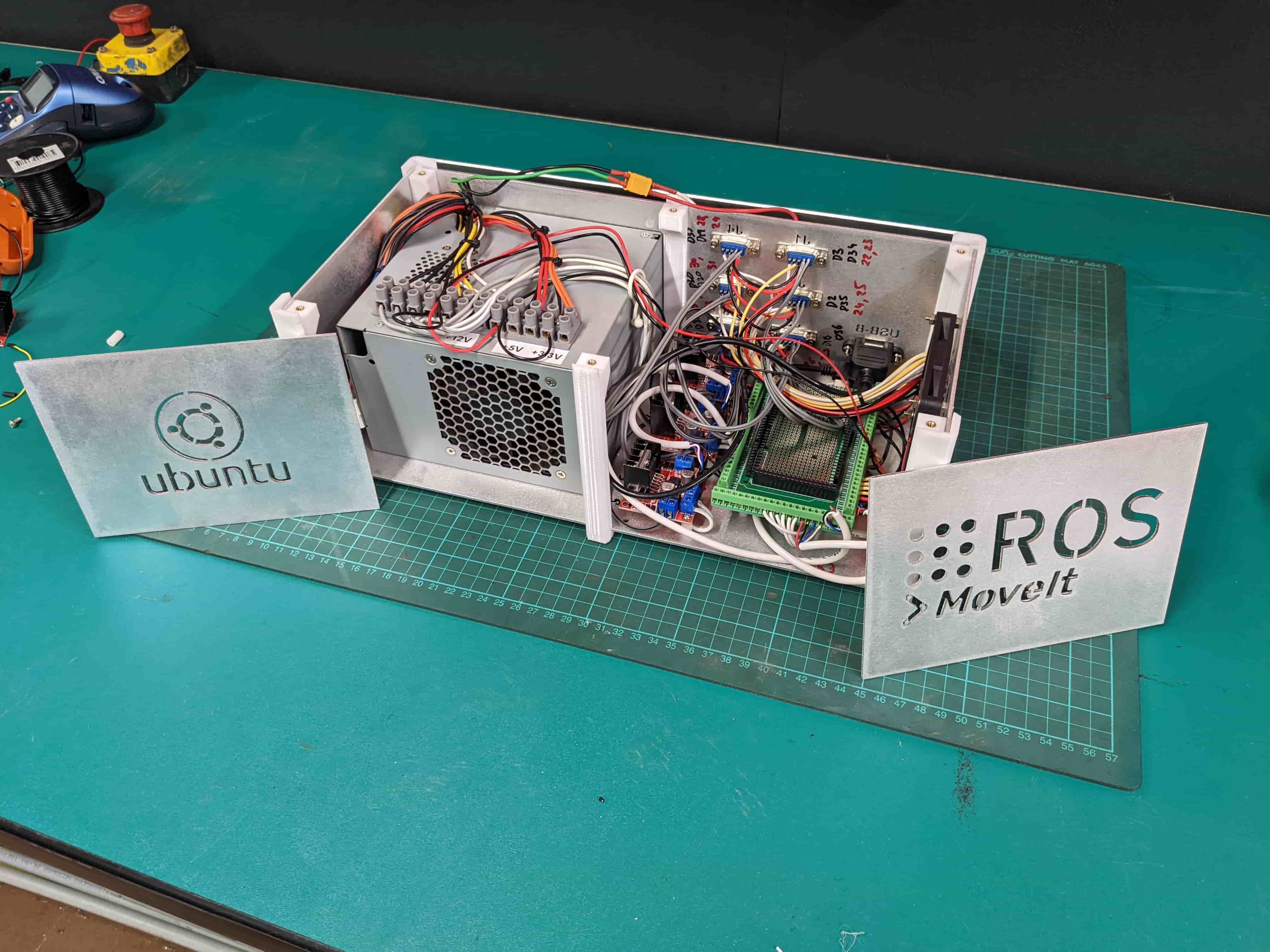 Open control enclosure showing the power supplies, motion controllers and internal wiring