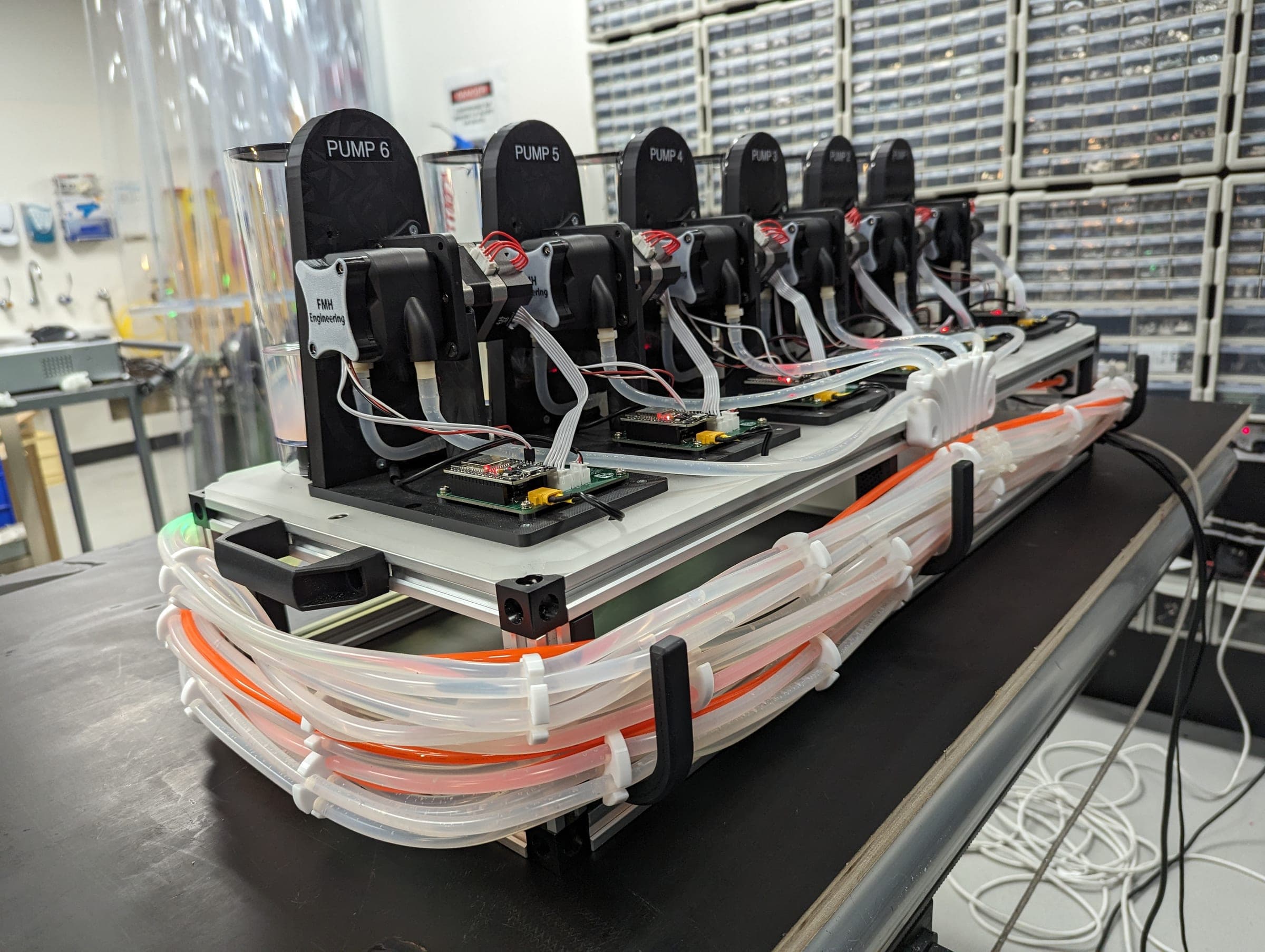 Side view of the six independently controlled peristaltic pump modules and routed fluid lines