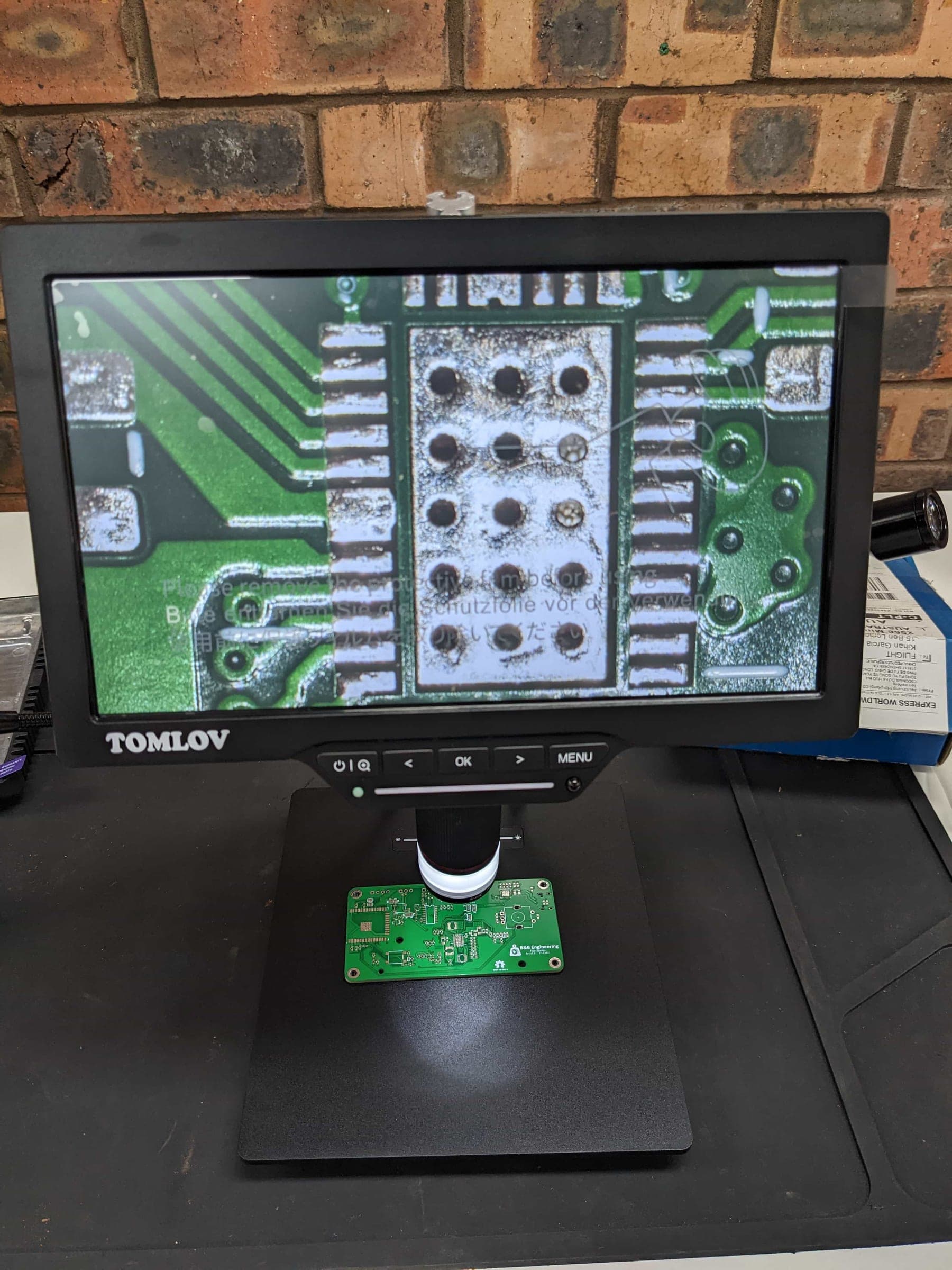 Fila-Scales circuit board being inspected and assembled under a digital microscope