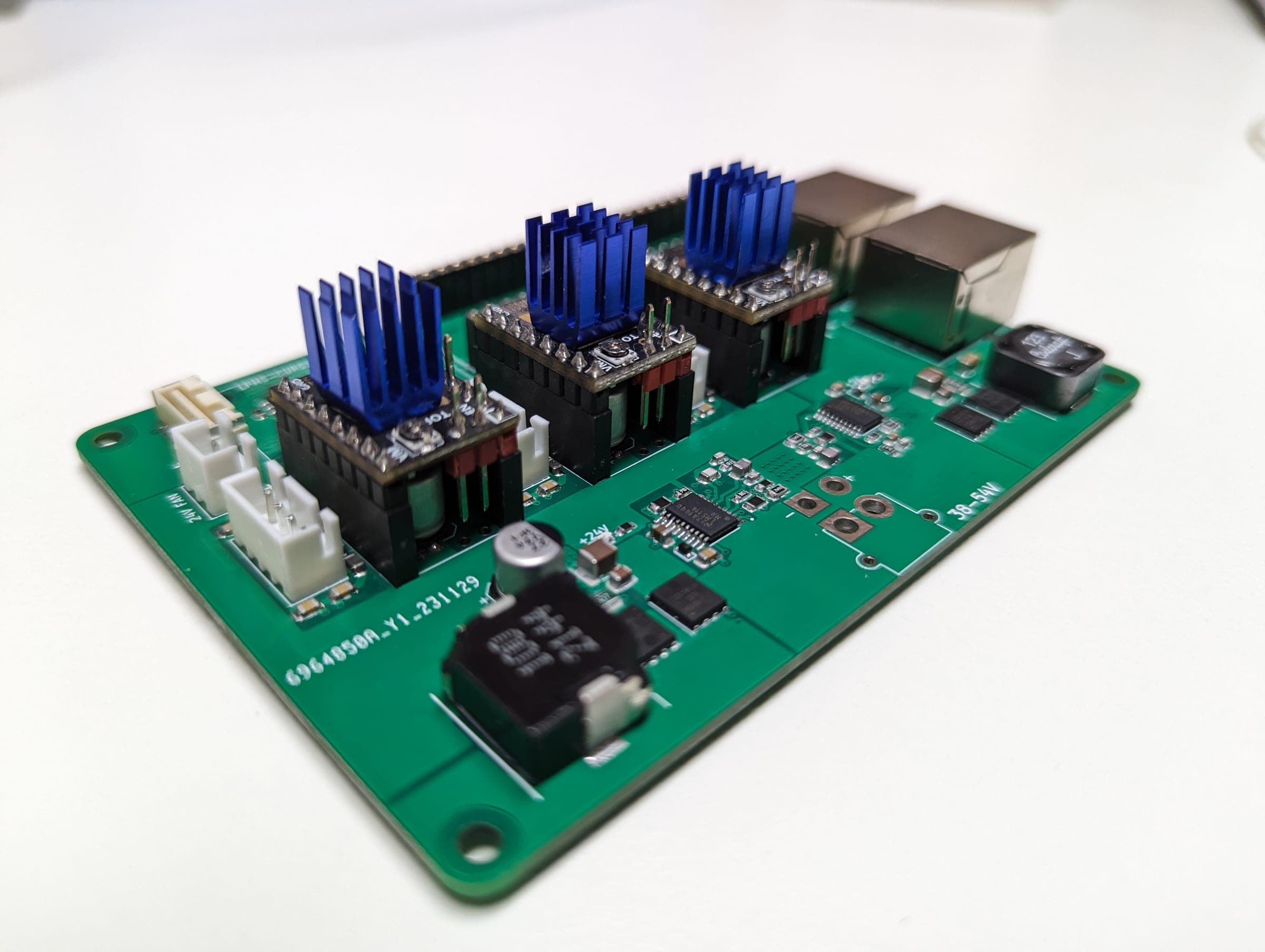 Low-angle detail of the carrier board power electronics and three motor-driver modules