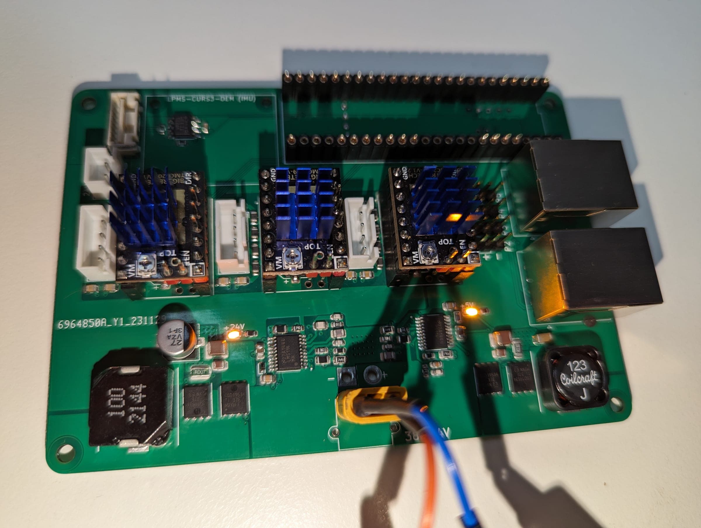 Powered carrier board under test with its motor drivers and regulated power rails active